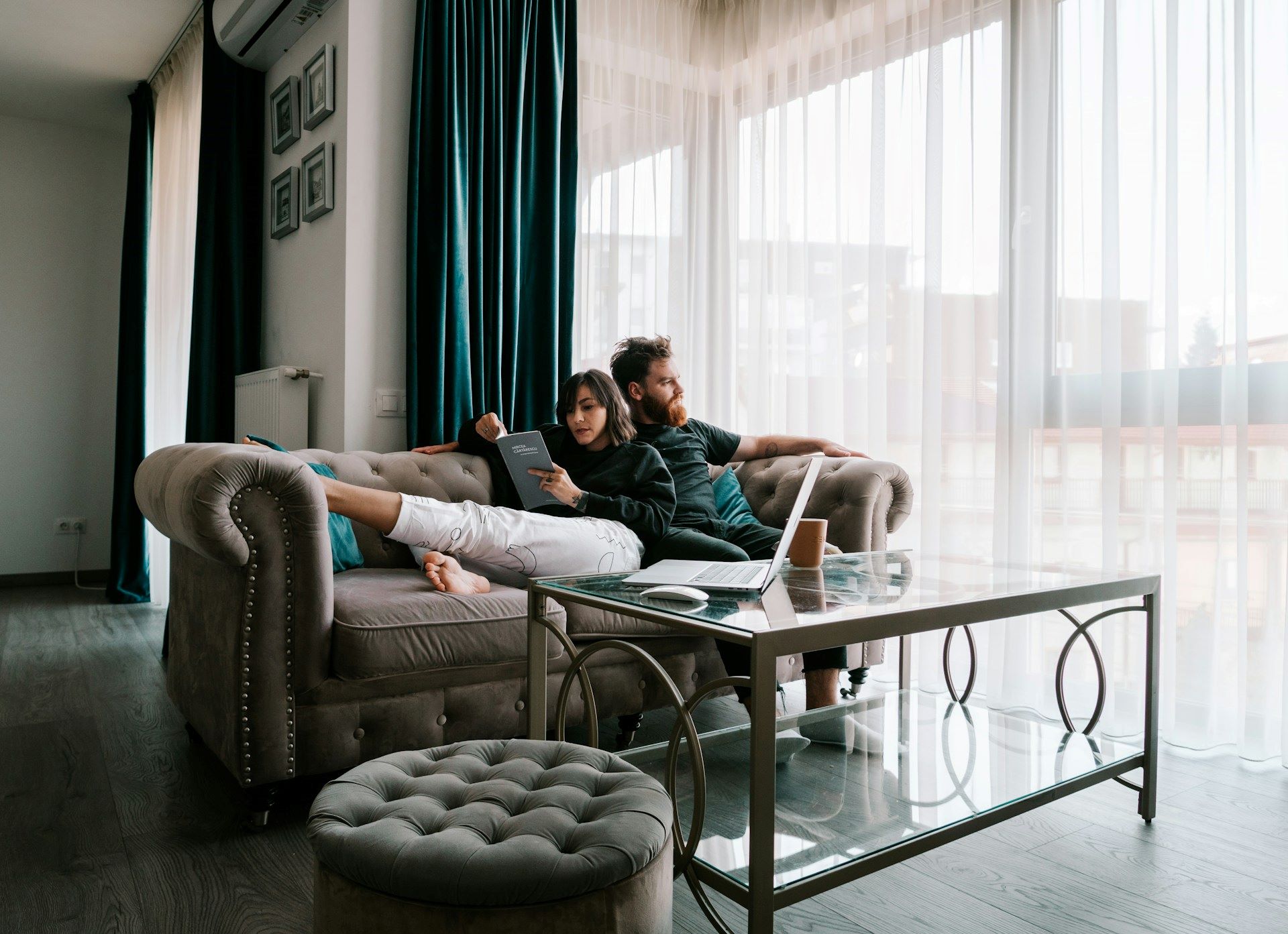 Couple sat on sofa in living room