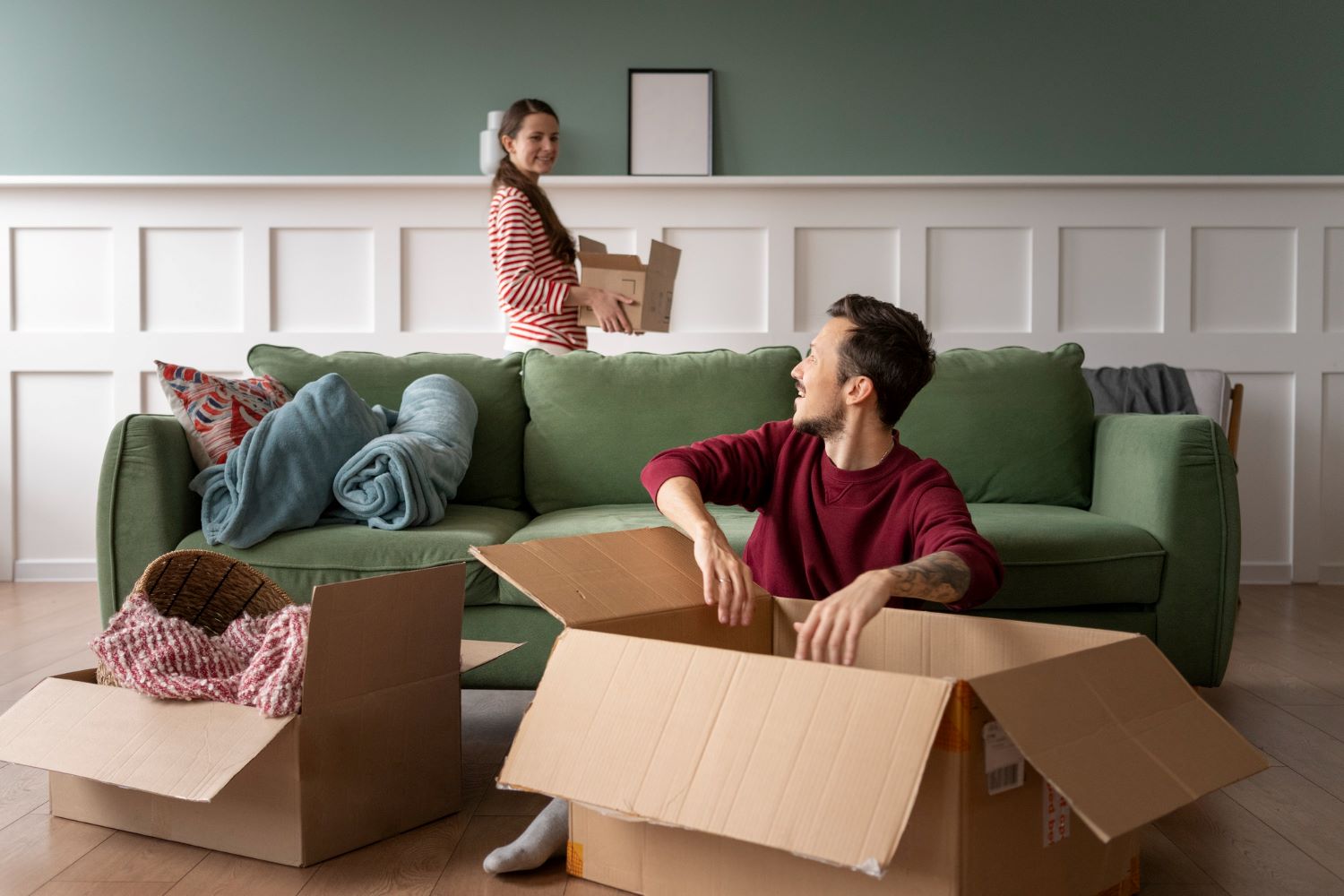 Man and women unpacking boxes