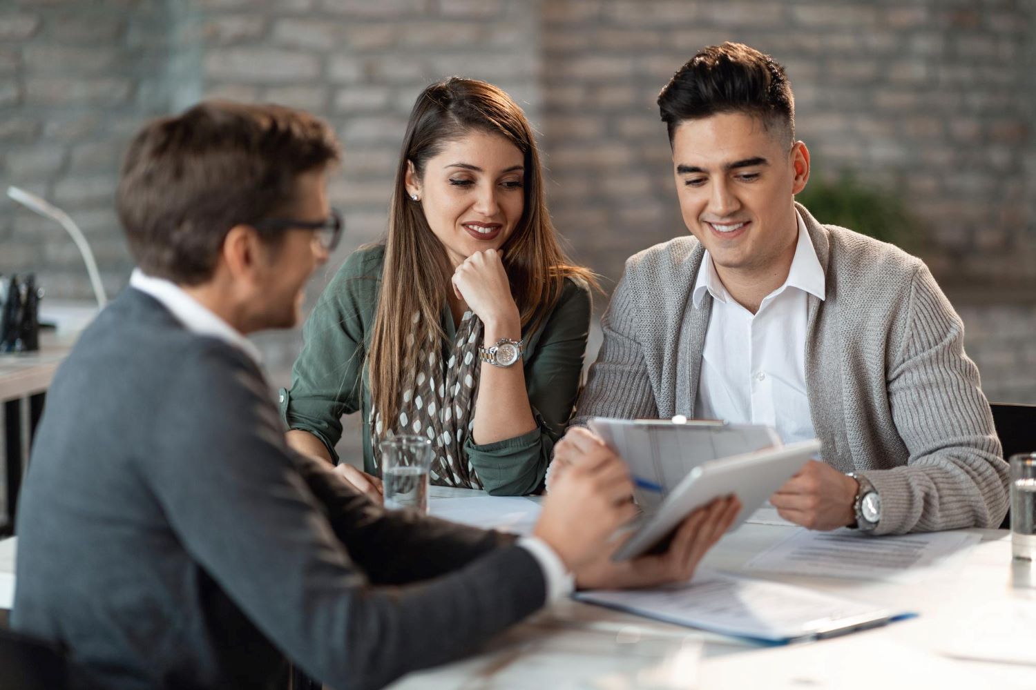 Man and women sat at table with mortgage adviser